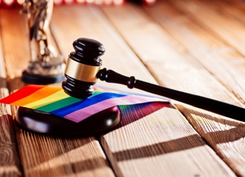 Judge wooden mallet - symbol of law and justice with lgbt rainbow colours flag