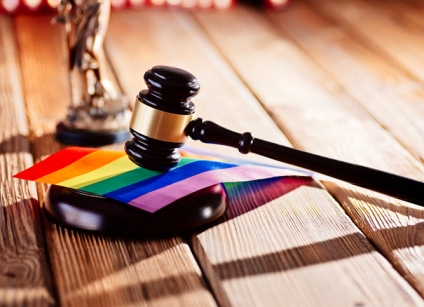 Judge wooden mallet - symbol of law and justice with lgbt rainbow colours flag