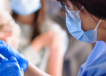 doctor injecting vaccine for students in high school picture id1302743677 1 e1630362934979