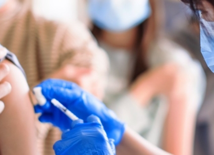 doctor injecting vaccine for students in high school picture id1302743677 1 e1630362934979