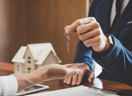 Real estate agent Sales manager holding filing keys to customer after signing rental lease contract of sale purchase agreement, concerning mortgage loan offer for and house insurance