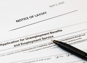 Job layoff notice and application for unemployment insurance benefits paperwork. Concept of Covid 19 coronavirus and stay at home order impact on economy
