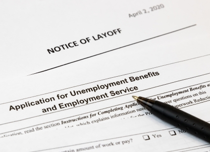 Job layoff notice and application for unemployment insurance benefits paperwork. Concept of Covid 19 coronavirus and stay at home order impact on economy