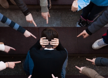 a lonely sad kid being bullied from his mates. A bullying scene